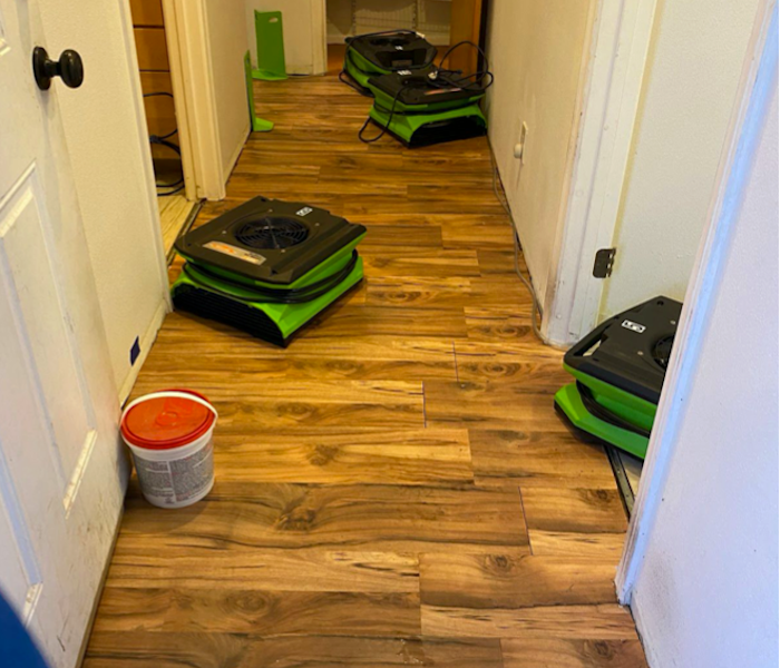 Hardwood floor with SERVPRO drying equipment in the hallway