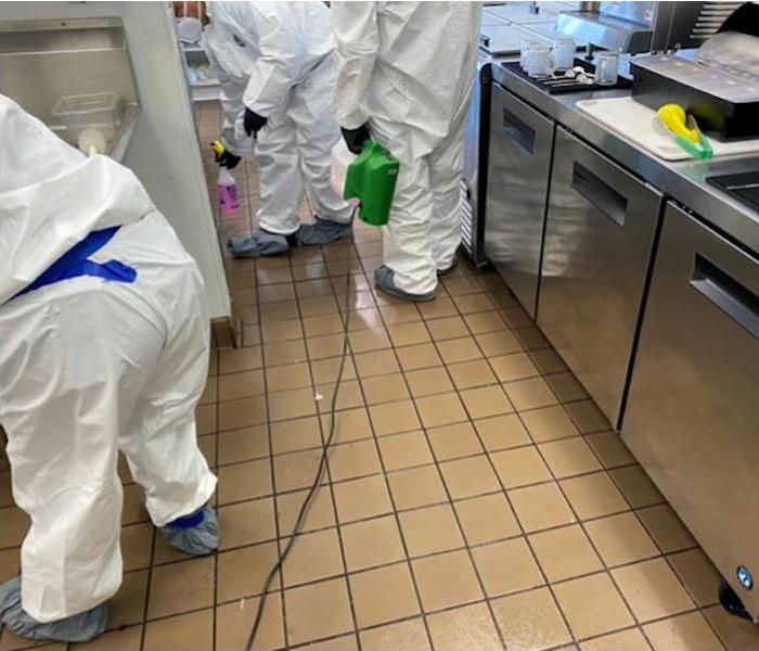 SERVPRO technicians in commercial kitchen with cleaning equipment