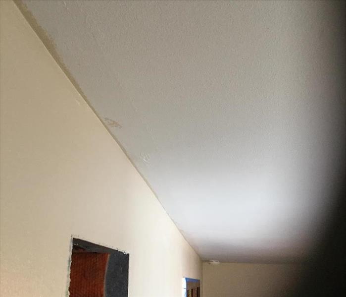 water stained ceiling, door casing removed from wet walls