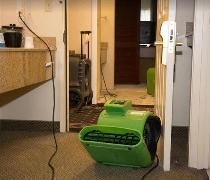 SERVPRO restoration equipment being used in water damaged rooms