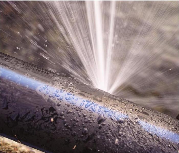 Water spewing from leak in pipe