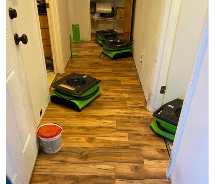 SERVPRO equipment on the floor in a hallway